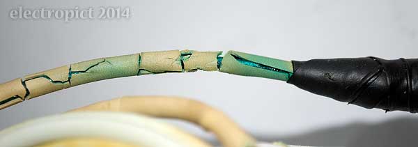 close up view of heavily cracked cable sheath